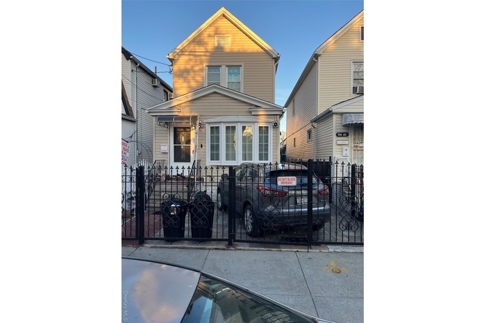 View of front facade featuring a fenced front yard and a gate