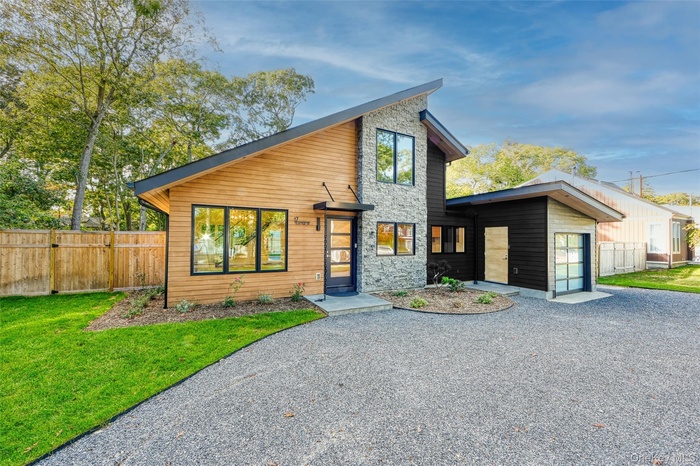 Contemporary house featuring stone siding