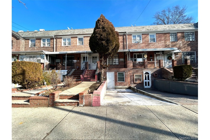 Traditional home with brick siding and a porch