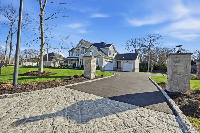 What an entrance!  Belgium Block apron and curbing, lighted stone driveway columns