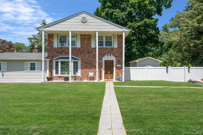 Greek revival inspired property featuring brick siding