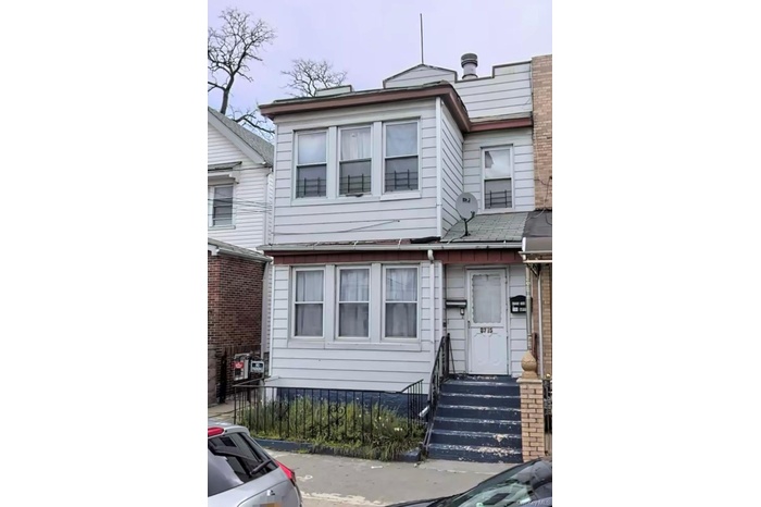View of property featuring a fenced front yard and entry steps