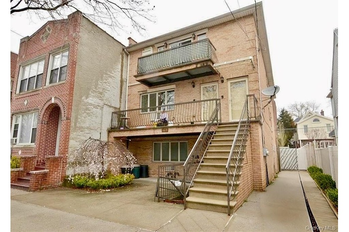 Front with driveway & outside entrance to basement