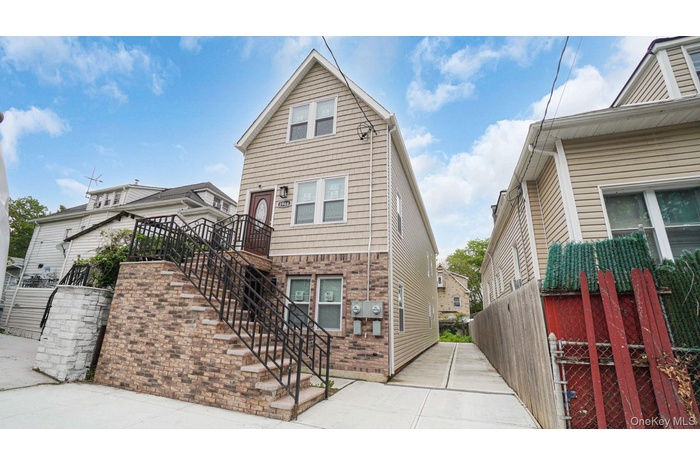 View of home's exterior featuring brick siding and stairway
