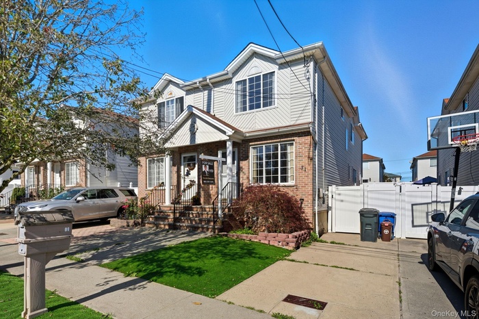 View of front of home featuring brick siding