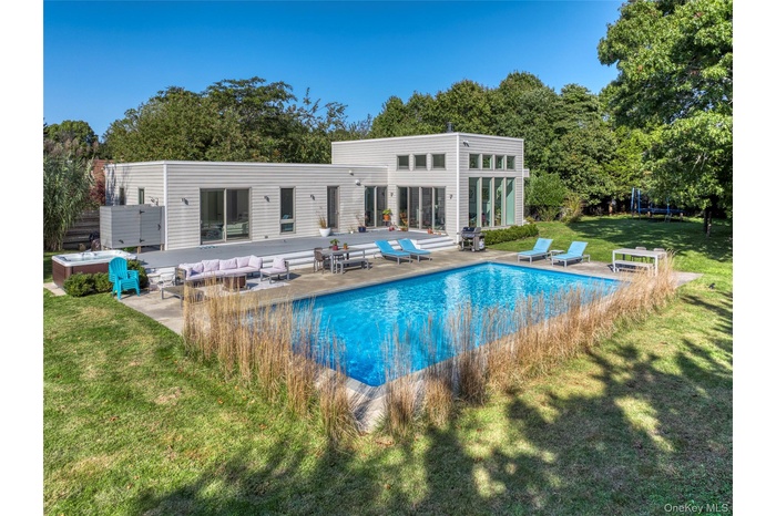 View of pool with outdoor lounge area, a patio area, a yard, and grilling area