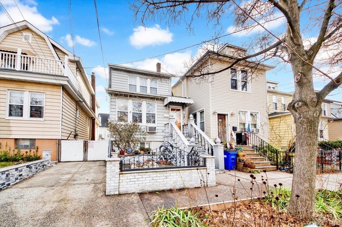 View of front facade featuring a fenced front yard and a gate
