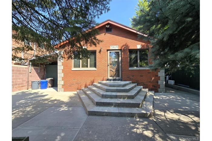 View of front facade featuring brick siding and a patio