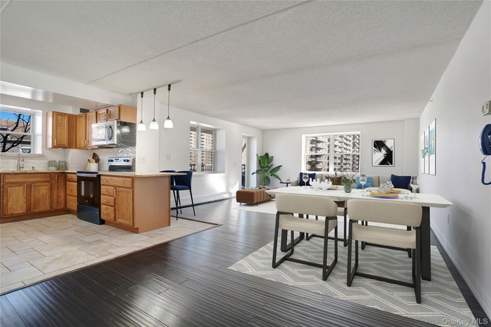 Dining room with a textured ceiling and light wood finished floors