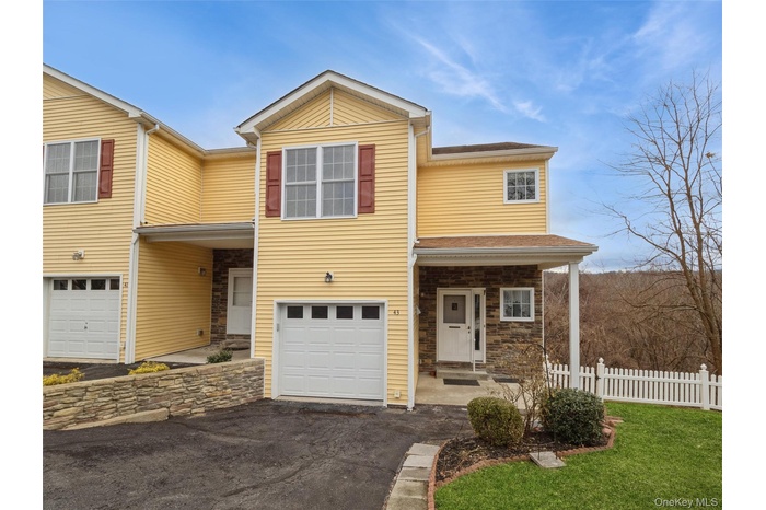 Front of townhouse showing access to garage and entrance