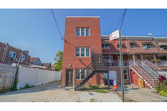 Back of property with brick siding and stairway