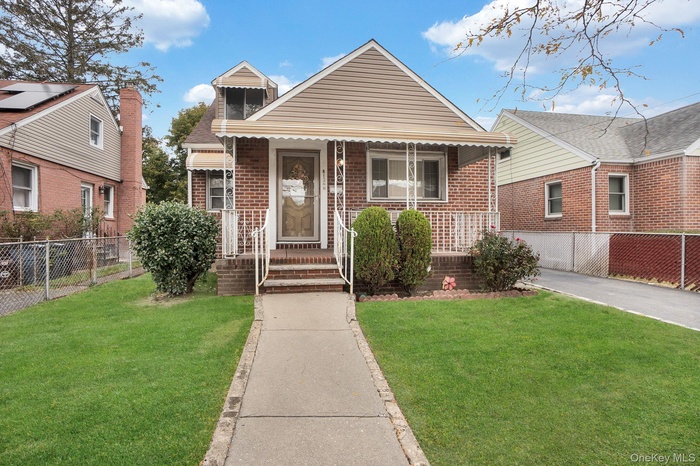 Bungalow-style home featuring brick siding and a porch