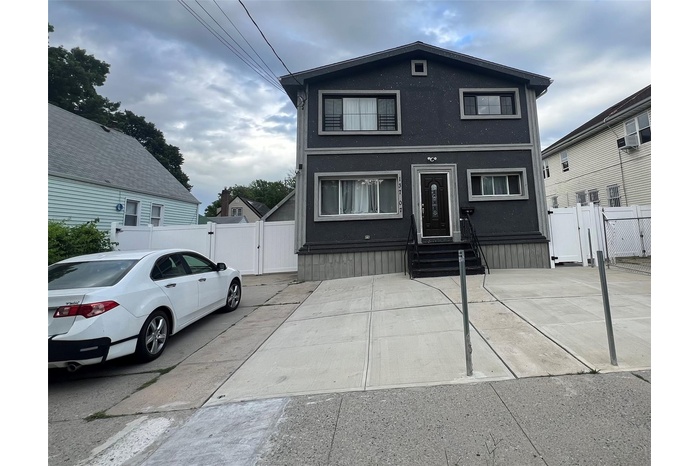 Traditional-style home with a gate, entry steps, and stucco siding