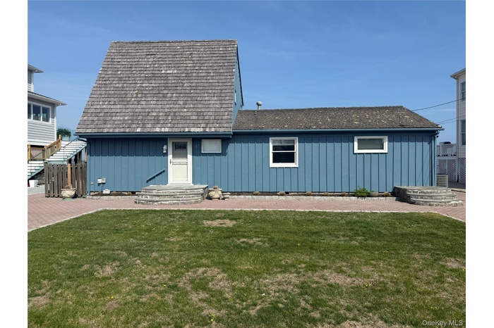 View of front of home with board and batten siding and a front lawn