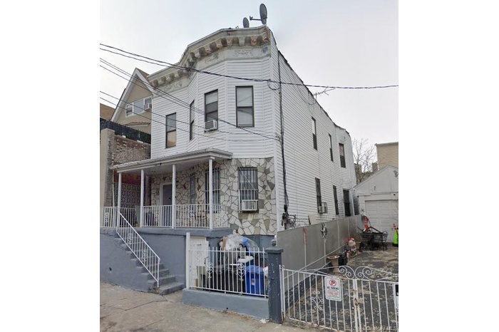 Multi unit property with a porch, stone siding and stairway