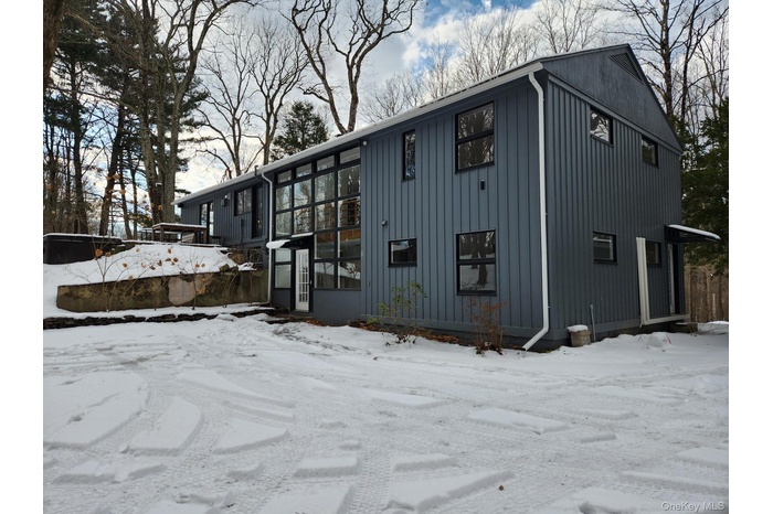 Back of home with parking area