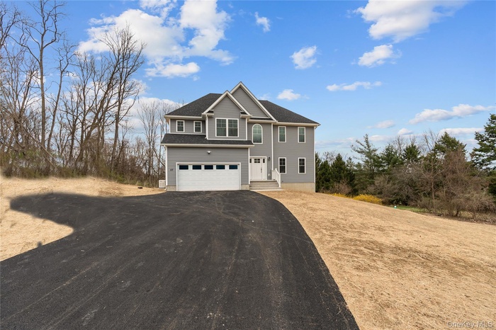 Traditional-style house featuring driveway and an attached garage
