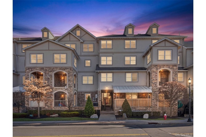 View of front of home with stone siding and stucco siding