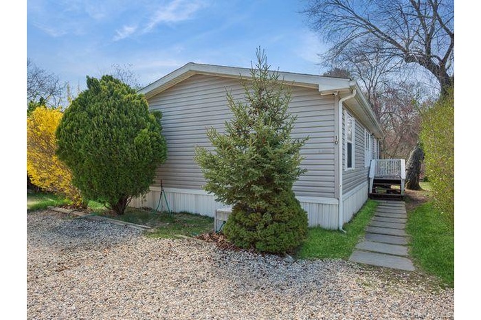 View of side of home with a wooden deck