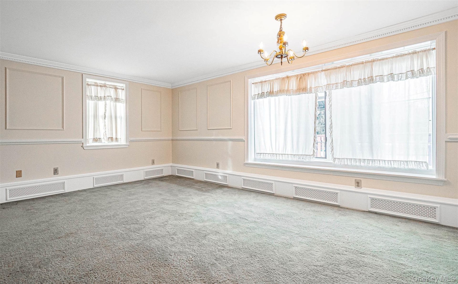 Dining room featuring a decorative wall and a chandelier