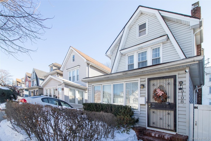 Dutch colonial featuring a gambrel roof and a chimney