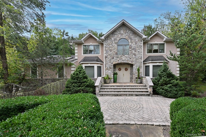 Traditional Colonial home featuring stucco & stone
