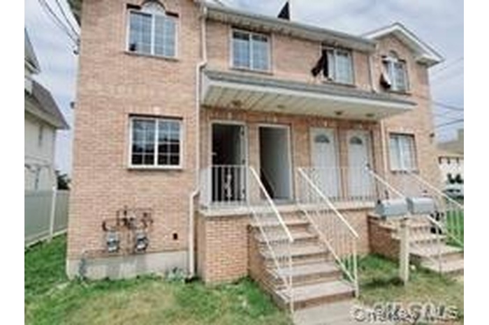 Traditional-style home featuring a porch and brick siding