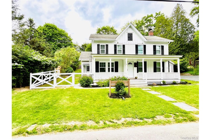 View of front of property with a front yard and a porch