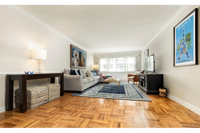 Living room featuring ornamental molding and baseboards