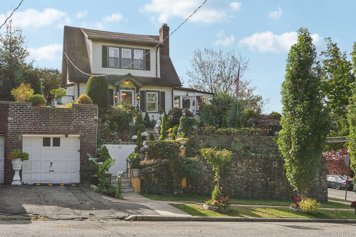 Colonial inspired home with a garage and a chimney