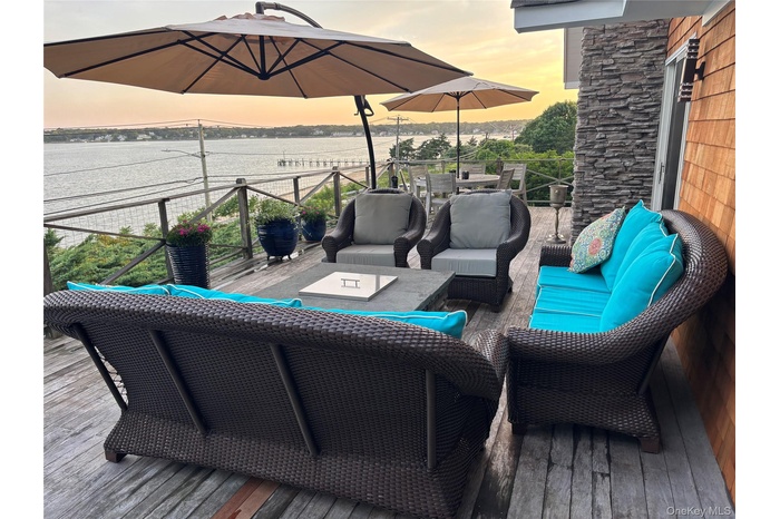 Wooden deck featuring an outdoor living space and a water view