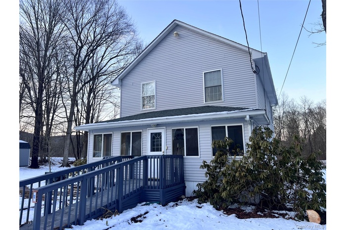 Home with access ramp and enclosed porch.