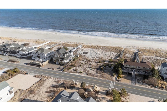 Aerial view of residential area featuring unending shoreline