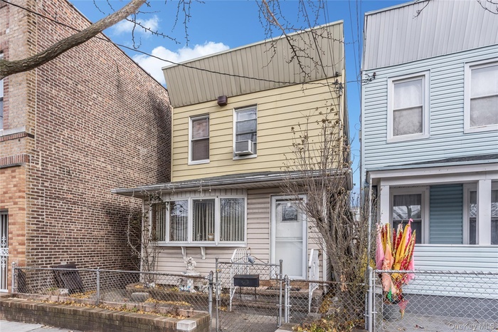 View of front of property with a gate and a fenced front yard