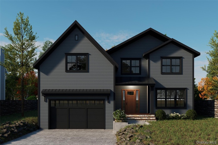 View of front of home featuring a garage, driveway, and a metal roof