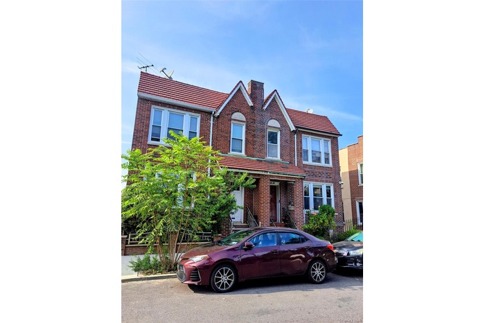 Traditional-style home featuring brick siding and a chimney