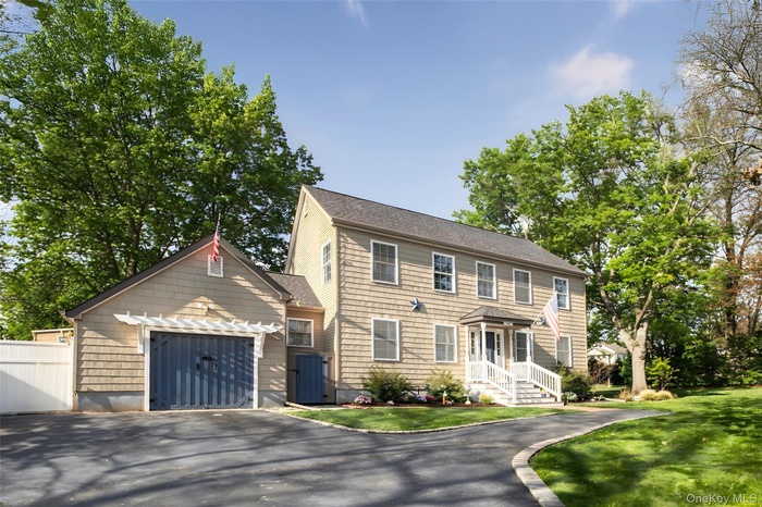 Colonial house with driveway and an attached garage