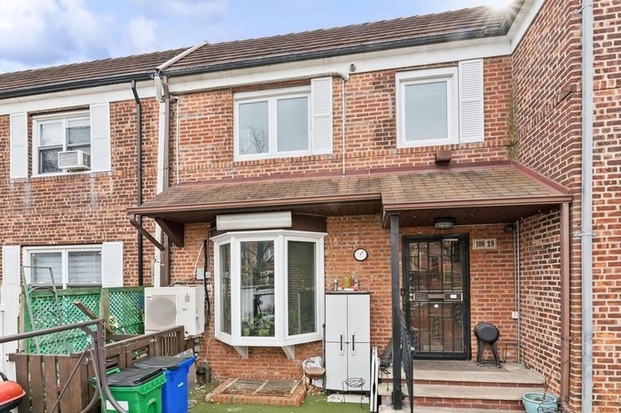 Townhome / multi-family property featuring brick siding, ac unit, a wall unit AC, and cooling unit