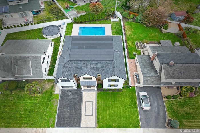 Aerial perspective of suburban area featuring a pool area