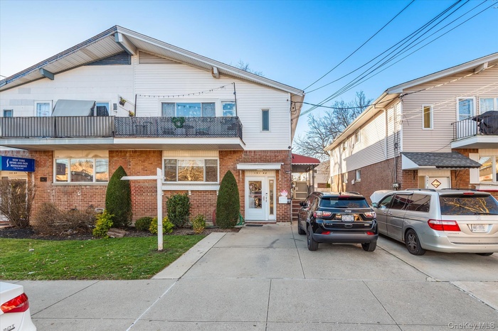 Traditional-style home with a balcony and brick siding