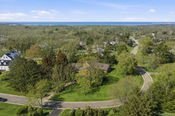 Aerial view of property and surrounding area featuring a heavily wooded area