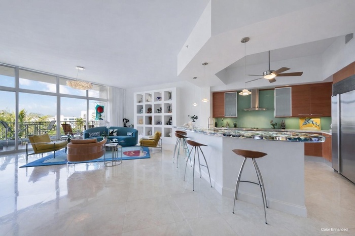 Color enhanced showing living area painted white.