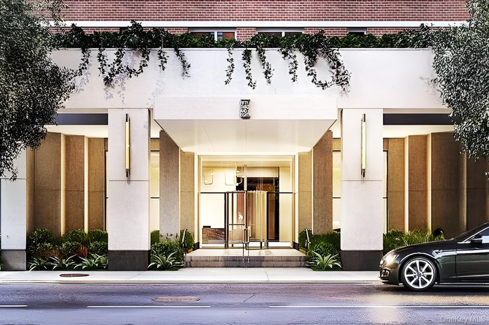 Property entrance featuring brick siding and stucco siding
