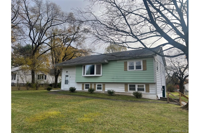 View of front of property with a front yard
