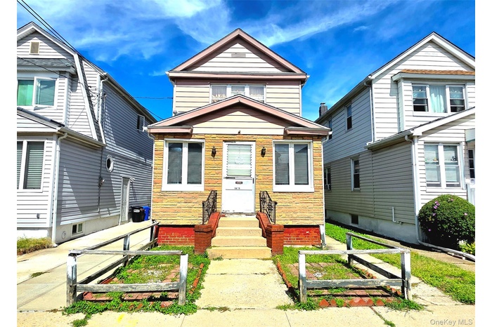 View of front facade, front lawn, and private driveway
