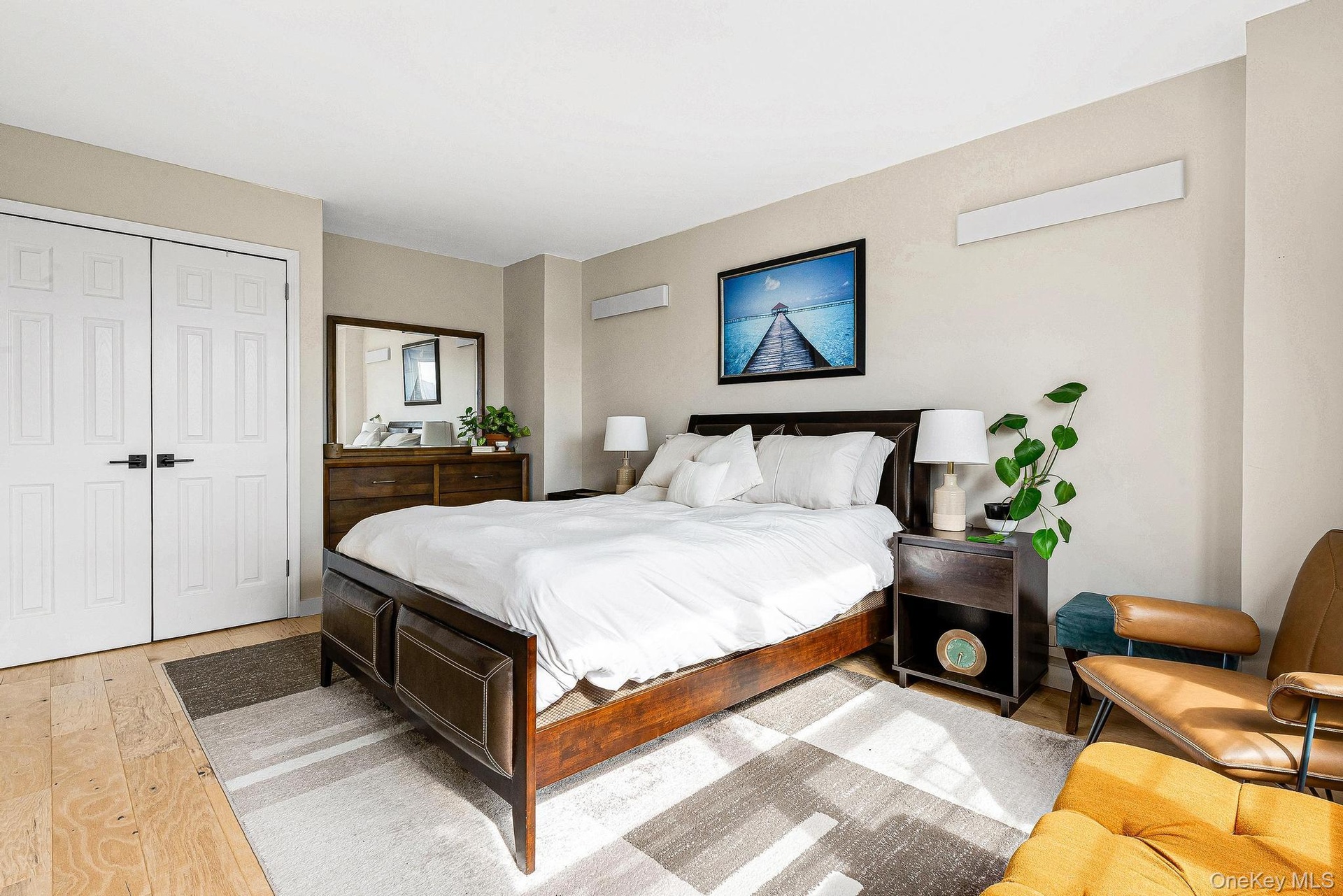 Bedroom featuring light wood finished floors and a closet