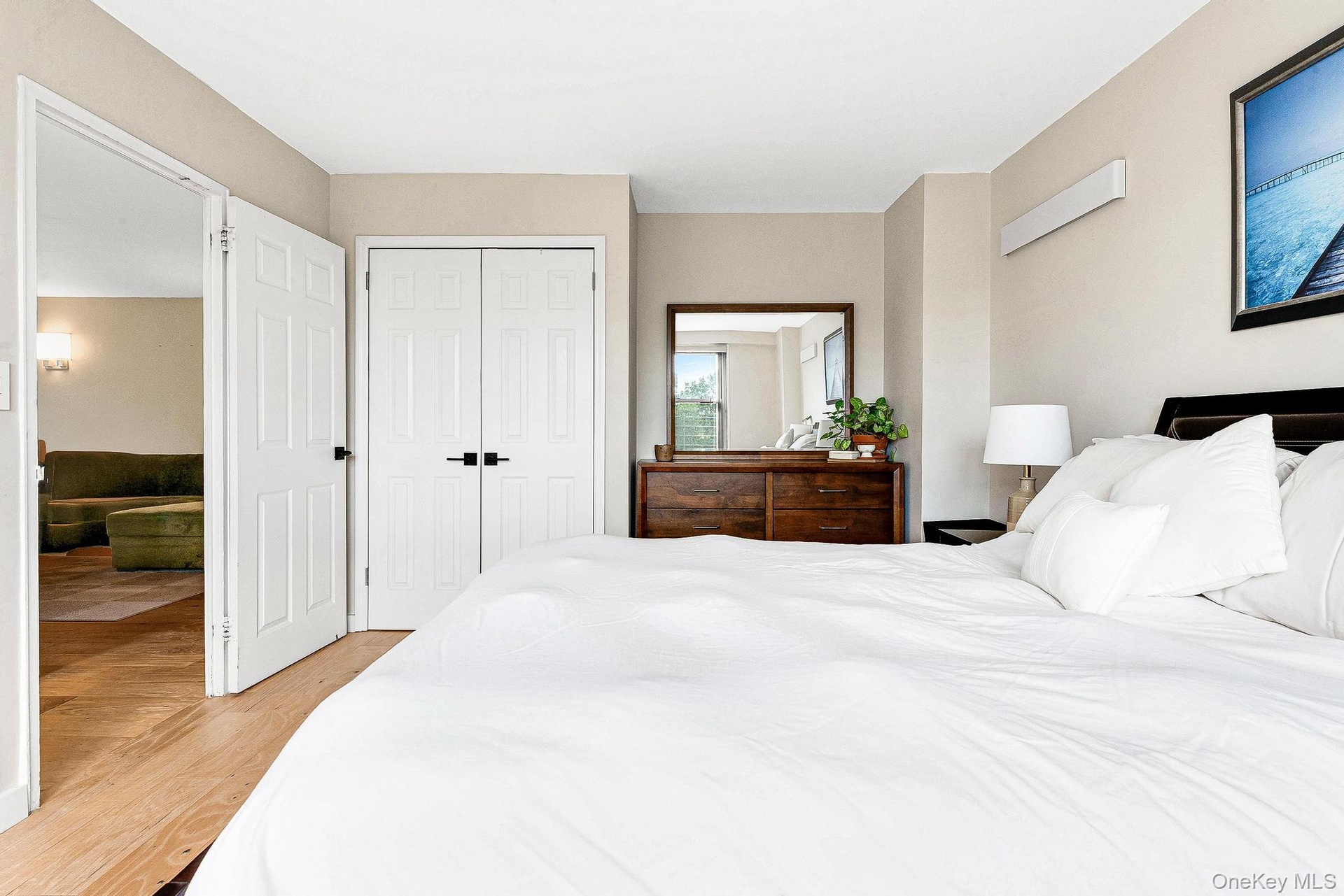 Bedroom featuring light wood finished floors and a closet