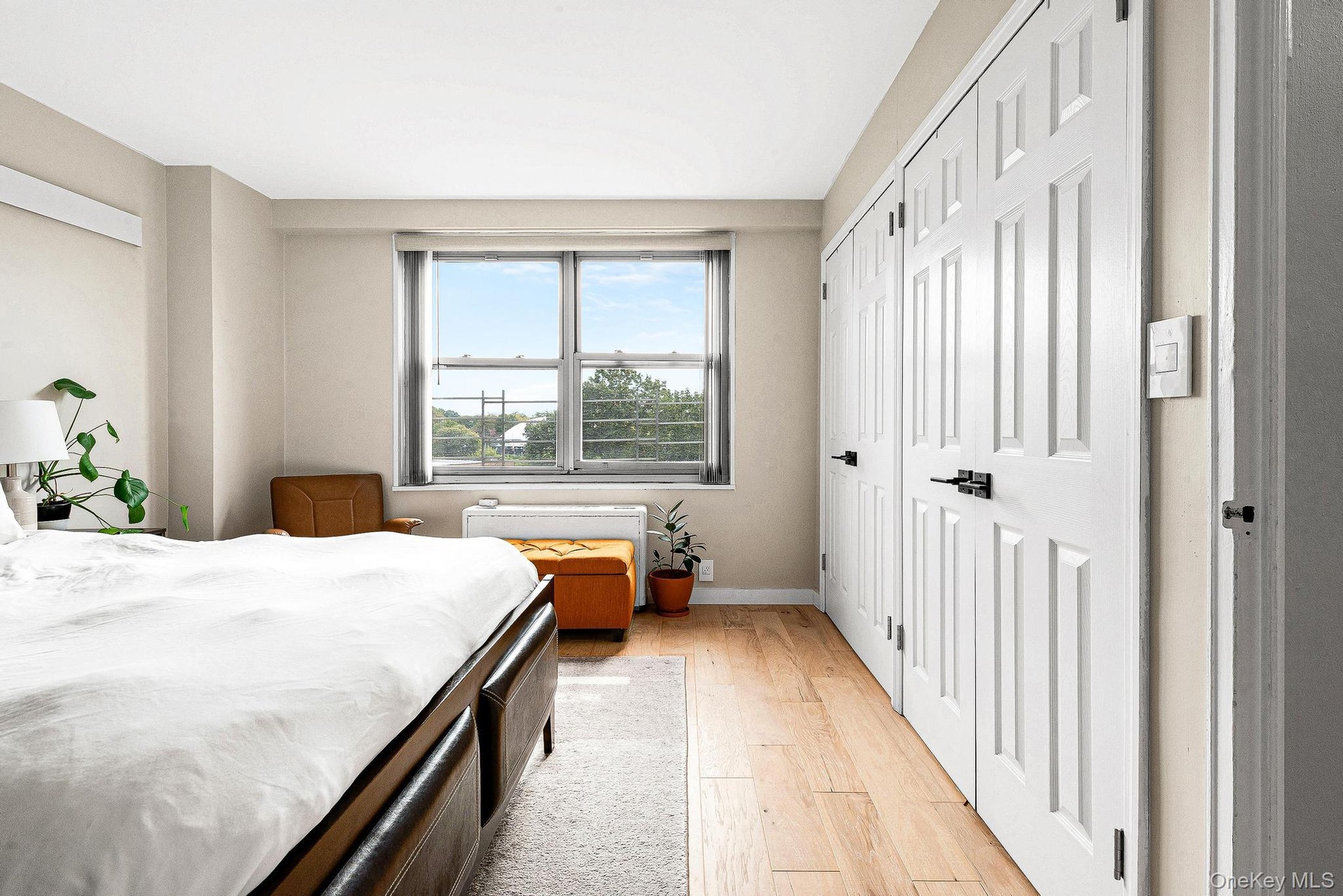 Bedroom with light wood-type flooring and baseboards
