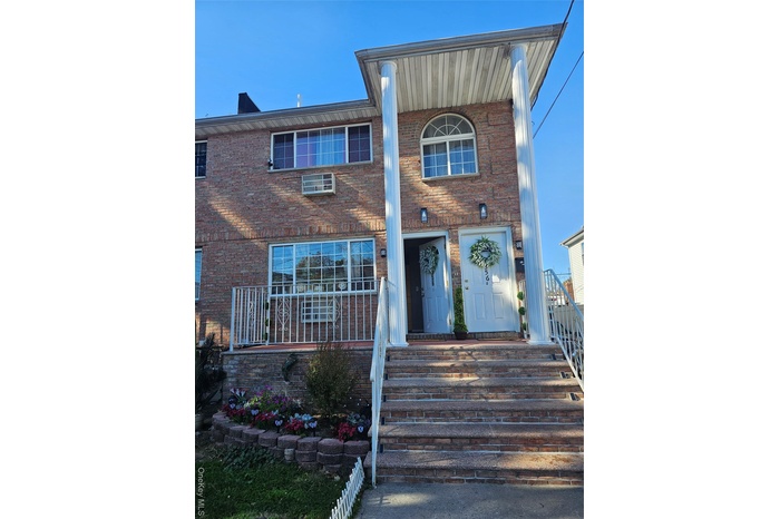 View of front facade featuring brick siding