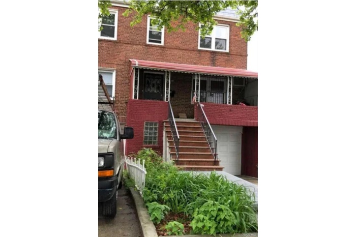 View of front facade featuring brick siding and stairway